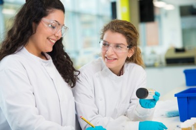 Two female researchers in biochemistry laboratory