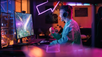 Male sitting in front of computer screen playing a video game