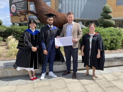 Surrey Business School student, Najam, receiving award from chair of Chartered Accountants South East Society, that recognises the highest grades in the University of Surrey's final year Institute of Chartered Accountants in England and Wales (ICAEW) accredited modules