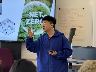 SII-DUFE student at Summer School 2025 presenting in front of screen in a classroom