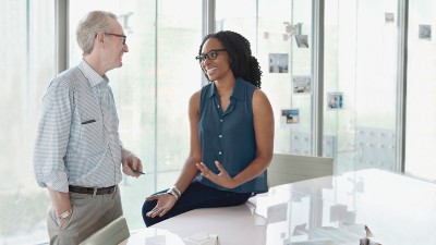 Man and woman talking in office