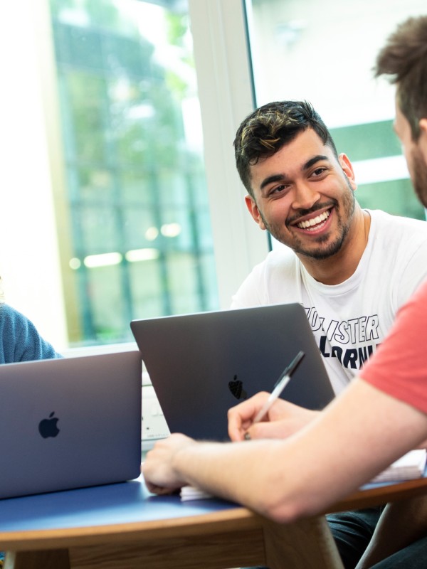 Students talking with laptop