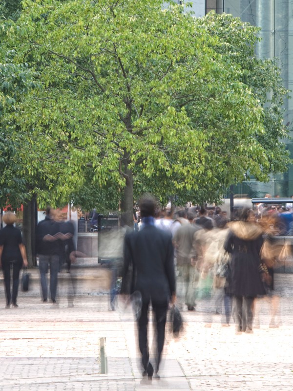 Crowd of people walking in city