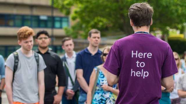 Helper speaking to students
