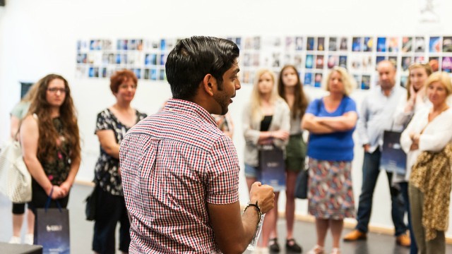 A student talking to a group of people