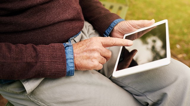 Elderly man using a tablet