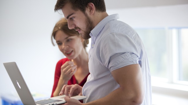 Woman and man looking at laptop screen