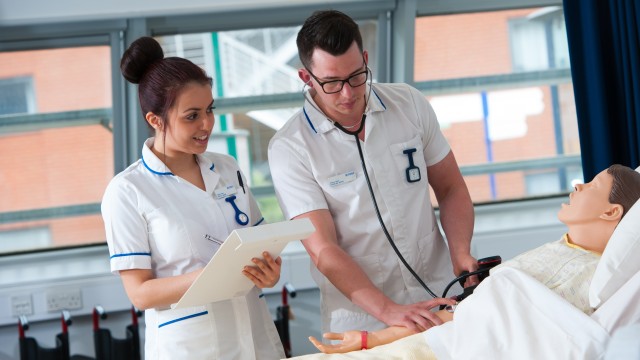 Adult nursing students working on a patient simulation