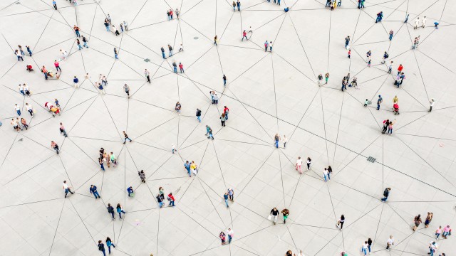 An aerial shot of a crowd of people with lines connecting them