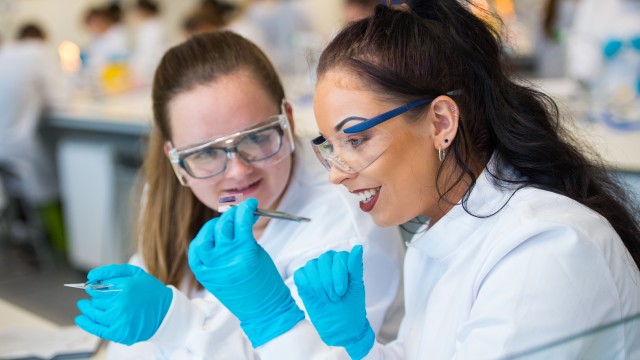 Students looking at a sample on a glass slide