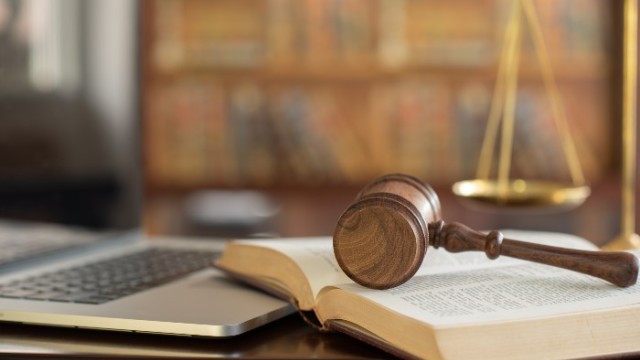 A gavel resting on a book 