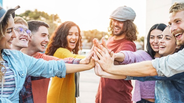 Group of people putting their hands together