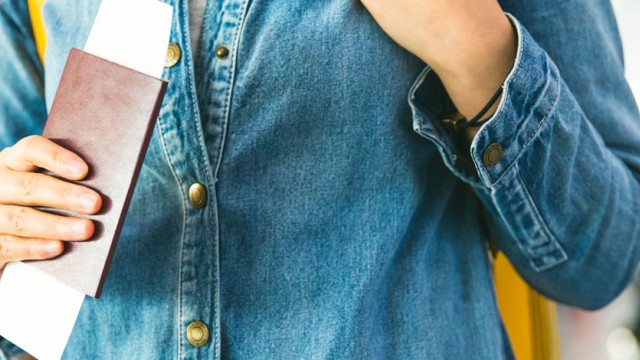 Person in airport holds a passport