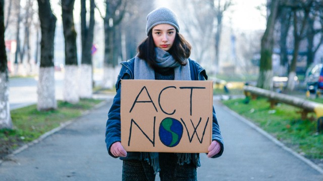 Young girl holding sign on climate change
