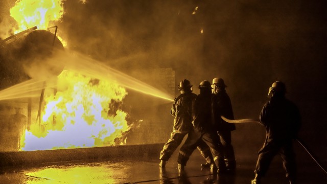 Firefighters extinguishing an industrial fire