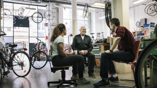People sitting and talking in a bike shop