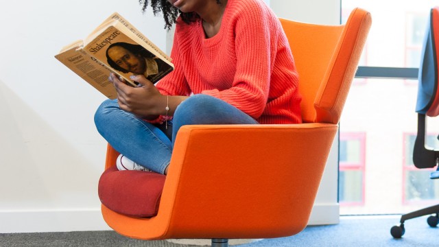 Student reading Shakespeare in the library