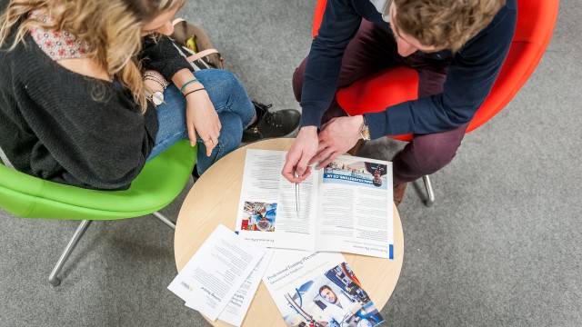 A member of staff talking through the placement process with a student
