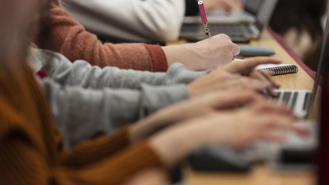 Hands typing on a laptop