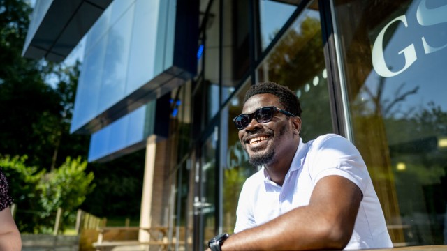 A student outside on campus in the sun