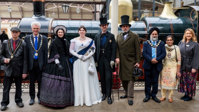 Dignatories and people in Victorian dress at Windsor Station