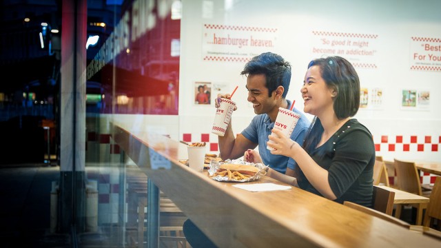 Students eating at Five Guys