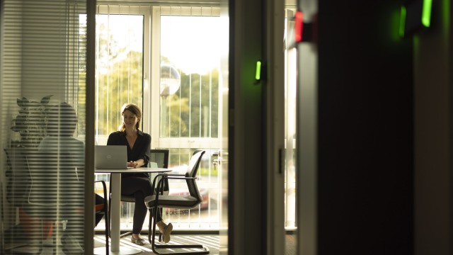A woman taking to a client in an office