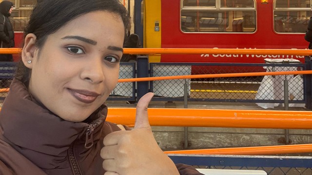 Geetanjali at Guildford train station giving a thumbs up