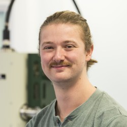 Portrait of Albert Woodward-Rowe in front of laboratory equipment.