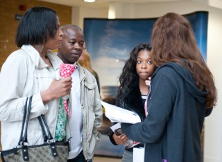 A student talking to a family 