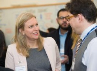 A man and woman talking at a business event