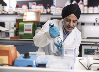 Hardev Pandha in the laboratory doing tests with tubes