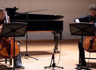Male and female playing the cello