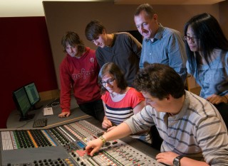 Professor Tony Myatt shows a group of Tonmeister students the mixing desk