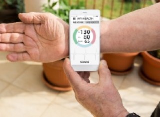 Person checking their heartbeat with tracker device
