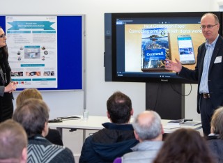 Caroline Scarles and David Frohlich in front of a screen