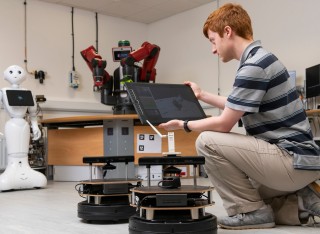 Electrical and electronic engineering student in robotics lab