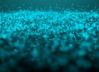 A glowing teal glitter cloud on a dark empty background 