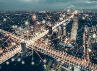 Lit up dots connected across a cityscape