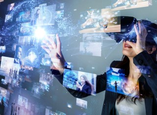 A lady uses virtual reality and interacts with the projections on screen