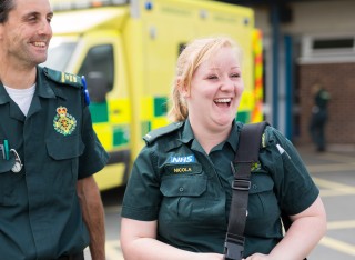 Paramedic student walking next to qualified paramedic