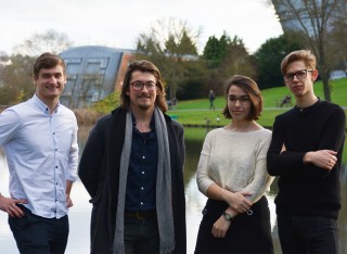 Sapphire Lally standing with members of the Leverhulme Quantum Biology Doctoral Training Centre by the lake