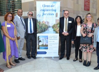 Attendees standing in front of poster
