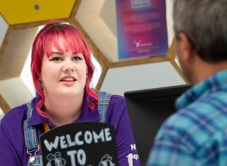 Student talking to a member of the public