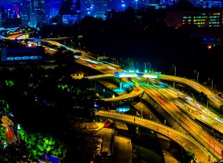 Busy intersection at night in Kuala Lumpur