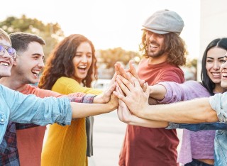 Group of people putting their hands together
