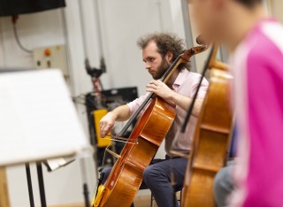 Music master's student playing cello