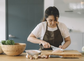 Getty - woman chopping meat