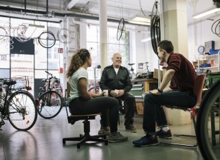 People sitting and talking in a bike shop
