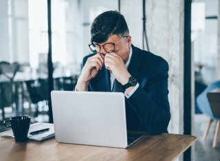Office worker sitting in front of laptop